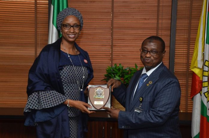 Dr. Maikanti Baru (r) presenting a plaque to the visiting Nigerian Ports Authority MD, Hajia Hadiza Bala Usman at NNPC Towers in Abuja.