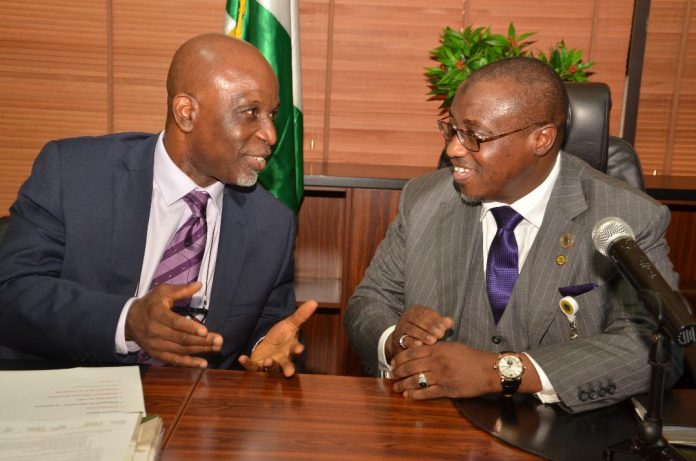 GMD NNPC, Dr. Maikanti Baru (right) in a discussion with Dada Thomas, President, Nigerian Gas Association, during a recent event