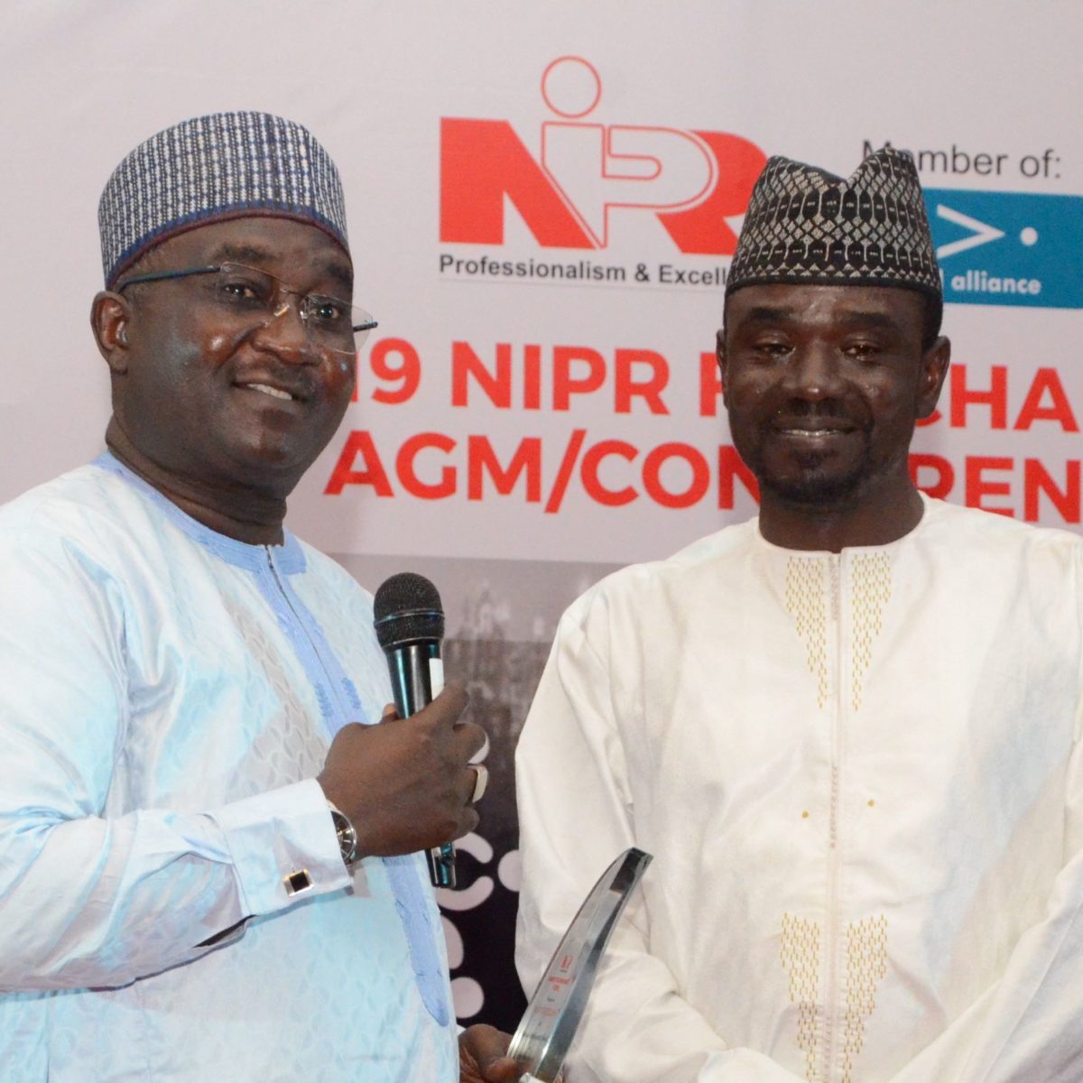 NIPR President, Malam Mukhtarr Sirajo presents Digital PR Practitioner Award to Yushau Shuaib in Abuja