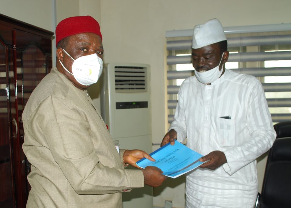 Chairman RMAFC Engr Elias Mbam receives ASVI reports from Yushau A. Shuaib of Economic Confidential