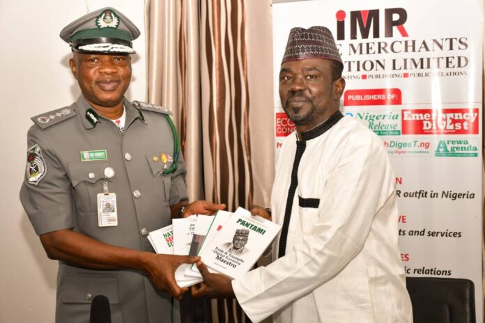 The Publisher of IMPR, Alhaji Yushau Shuaib Presenting Books to The Acting Comptroller-General of the Nigeria Customs Service (NCS), Mr Bashir Adewale Adeniyi