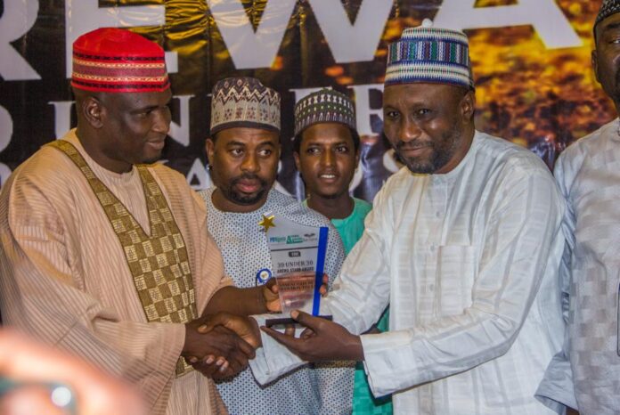 IMPR Board Chairman, Dr. Sule Ya'u Sule presenting award to the Kano State Governor's Spokesperson, Sanusi Bature Dawakin Tofa