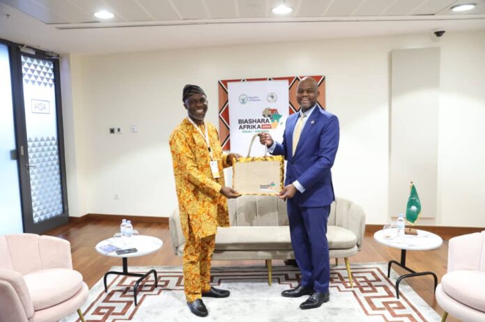 Picture: Olusegun Olutayo (Left), Senior Trade Expert/Lead, Trade Enablement, presenting a souvenir bag from the Nigeria AfCFTA Coordination Office to H.E. Wamkele Mene (Right), AfCFTA Secretary-General on the sidelines of Biashara Afrika 2024 on 11th October, 2024 in Kigali, Rwanda