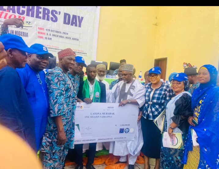 The Minister of State for Education, Dr Yusuf Tanko Sununu, COEASU Presenting Award to Best Student Mubarak Latona of FCE Iwo