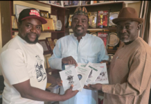 Alh.Yshauu Shuaib presenting books to Dr. Anthony Ogande and Dr. Ukam I. during a visit in Abuja