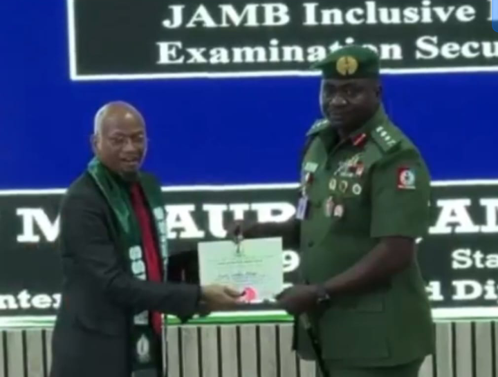 Deputy Director with the Joint Admissions and Matriculation Board (JAMB), Jamilu Musa Jauro receiving present from NISS
