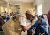 Medical personnel checking on a patient