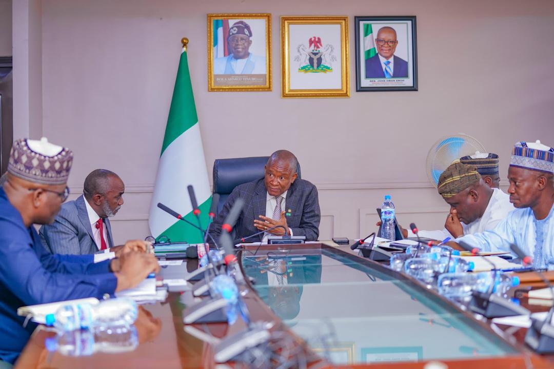 The Minister of State for Industry, Senator John Owan Enoh, receiving briefing from the Executive Secretary of the National Sugar Development Council (NSDC), Mr. Kamar Bakrin, and representatives of major sugar operators on the status of the Backward Integration Programme (BIP)