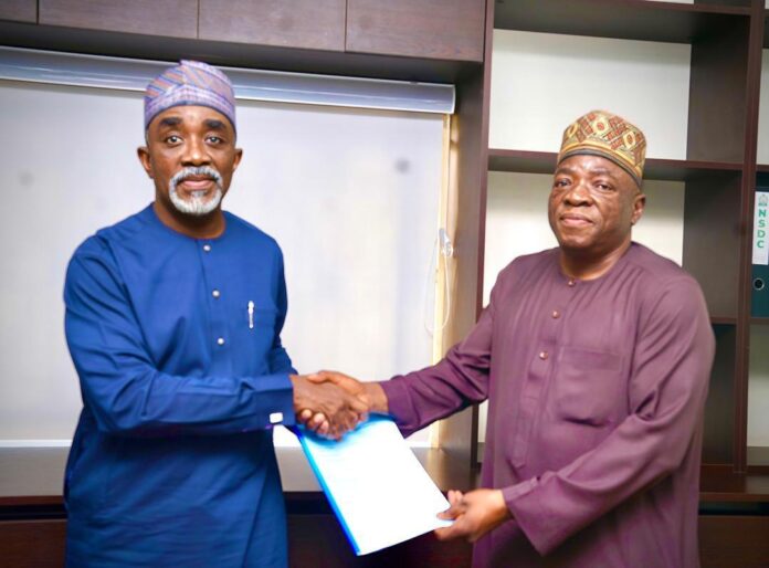 The Executive Secretary/CEO of the National Sugar Department Council (NSDC), Mr. Kamar Bakrin (L), with the CEO of Legacy Sugar Company, Alh. Abubakar Isa Musa (R), during the signing ceremony.